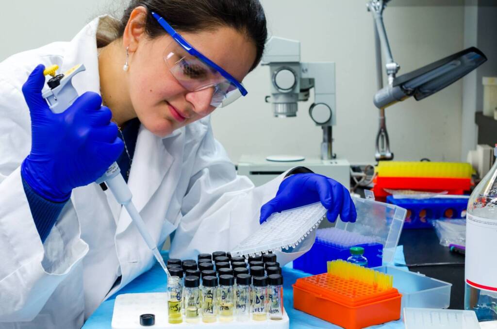 A lady doctor performing urine test in laboratory